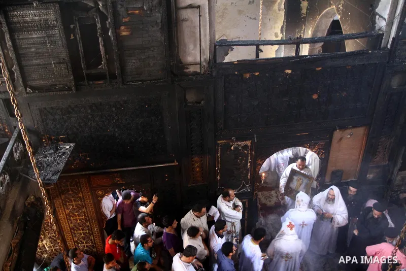 Egyptians Christians remove objects from the damaged Virgin Mary church in the popular area of Imbaba in the Egyptian capital of Cairo on May 8, 2011, after overnight clashes between Muslims and Christians which left 10...