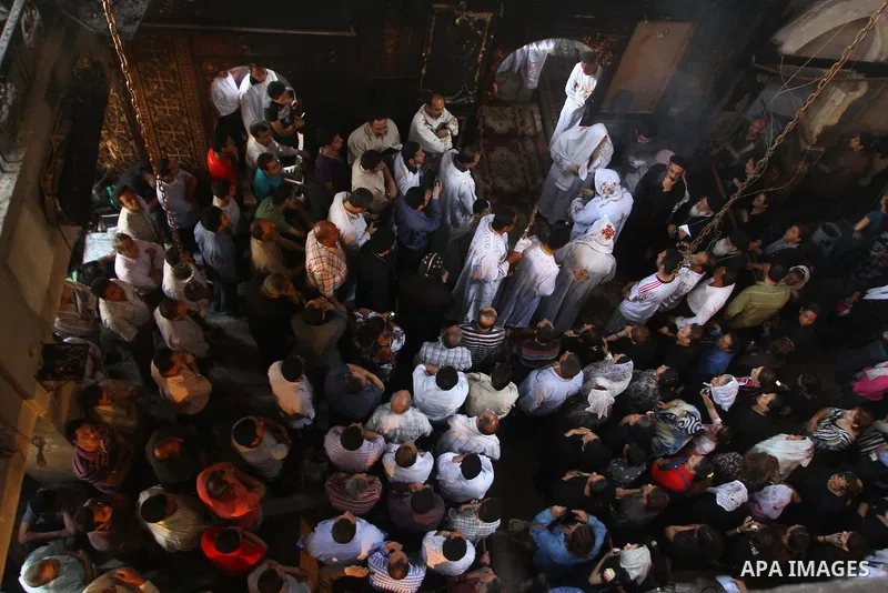 Egyptians Christians remove objects from the damaged Virgin Mary church in the popular area of Imbaba in the Egyptian capital of Cairo on May 8, 2011, after overnight clashes between Muslims and Christians which left 10...