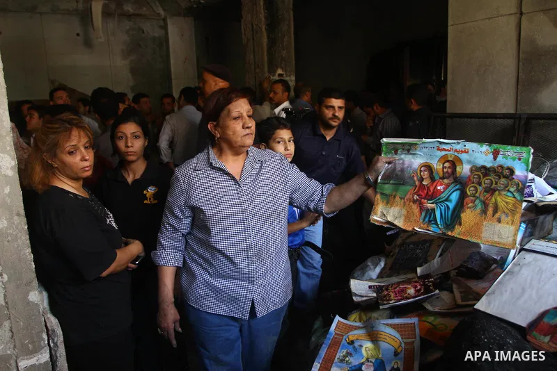 Egyptians Christians remove objects from the damaged Virgin Mary church in the popular area of Imbaba in the Egyptian capital of Cairo on May 8, 2011, after overnight clashes between Muslims and Christians which left 10...