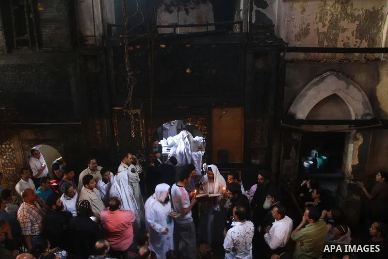 Egyptians Christians remove objects from the damaged Virgin Mary church in the popular area of Imbaba in the Egyptian capital of Cairo on May 8, 2011, after overnight clashes between Muslims and Christians which left 10...