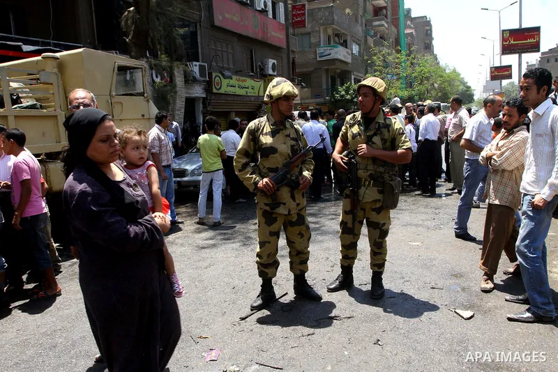 Egyptian military soldiers stand guard as Christians remove objects from the Virgin Mary church in the popular area of Imbaba in the Egyptian capital of Cairo on May 8, 2011 after clashes between Muslims and Christians w...