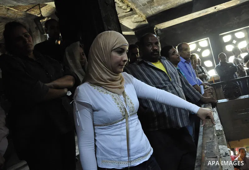 Egyptians Christian react at the damaged Virgin Mary church in the popular area of Imbaba in the Egyptian capital of Cairo on May 8, 2011, after overnight clashes between Muslims and Christians which left 10 people dead...