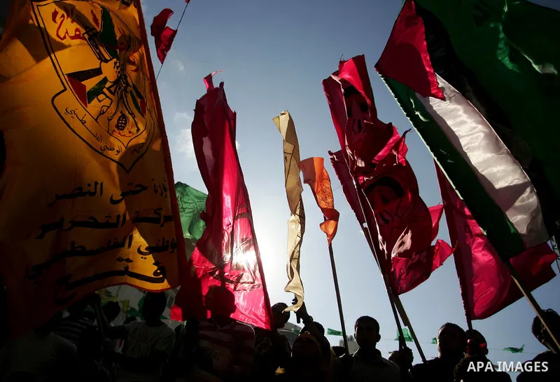 Palestinians participate in a rally celebrating the reconciliation agreement between Fatah and Hamas, at al-Azhar University in Gaza City, Sunday, May 8, 2011. Rival Palestinian factions Fatah and Hamas signed a landmark...