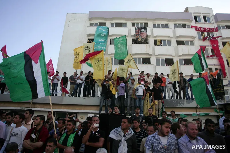 Palestinians participate in a rally celebrating the reconciliation agreement between Fatah and Hamas, at al-Azhar University in Gaza City, Sunday, May 8, 2011. Rival Palestinian factions Fatah and Hamas signed a landmark...
