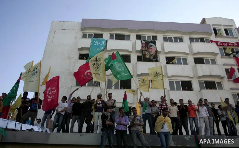 Palestinians participate in a rally celebrating the reconciliation agreement between Fatah and Hamas, at al-Azhar University in Gaza City, Sunday, May 8, 2011. Rival Palestinian factions Fatah and Hamas signed a landmark...