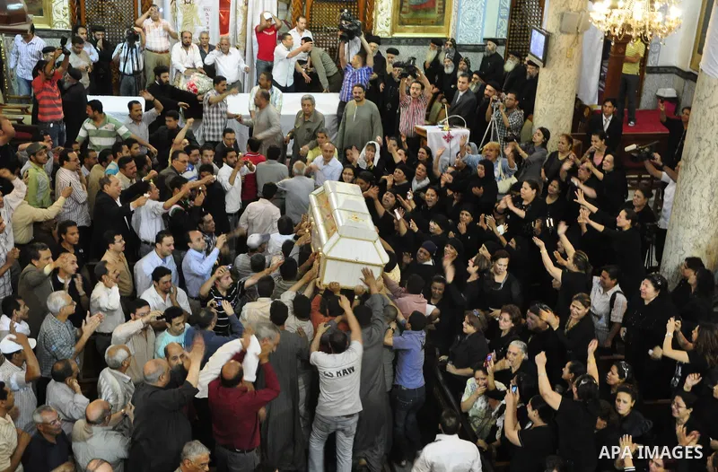 Egyptian Coptic Christians carry the coffin of a victim of sectarian clashes during a funeral in Cairo on May 8, 2011 as Egypt's military rulers warned they will use an "iron hand" to protect national security after clas...