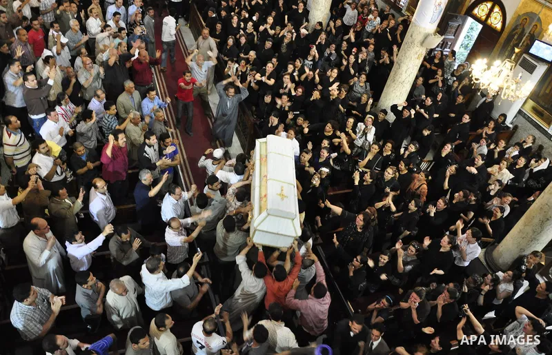 Egyptian Coptic Christians carry the coffin of a victim of sectarian clashes during a funeral in Cairo on May 8, 2011 as Egypt's military rulers warned they will use an "iron hand" to protect national security after clas...
