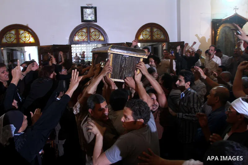 Egyptian Coptic Christians carry the coffin of a victim of sectarian clashes during a funeral in Cairo on May 8, 2011 as Egypt's military rulers warned they will use an "iron hand" to protect national security after clas...