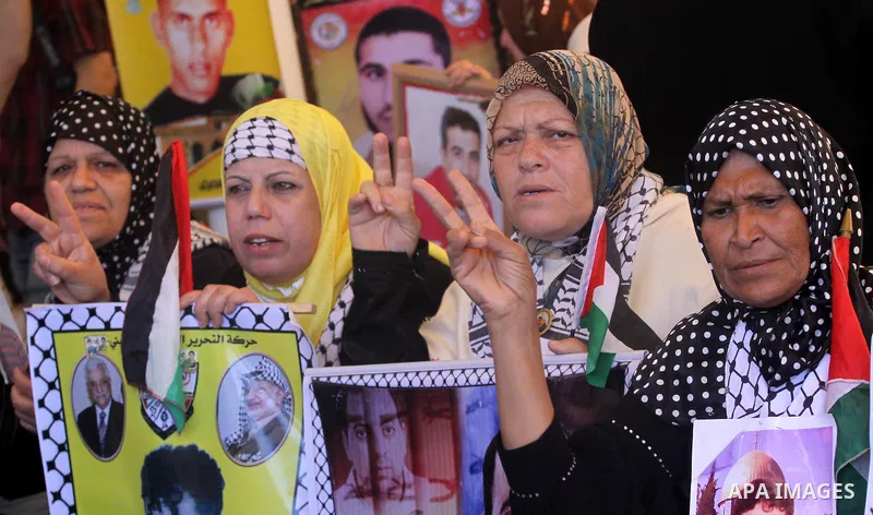 Palestinian women hold pictures of jailed relatives during a protest in Gaza city calling for their release from Israeli prisons at the headquarters of the International Red Cross in Gaza City May 9, 2011. Photo by Moham...