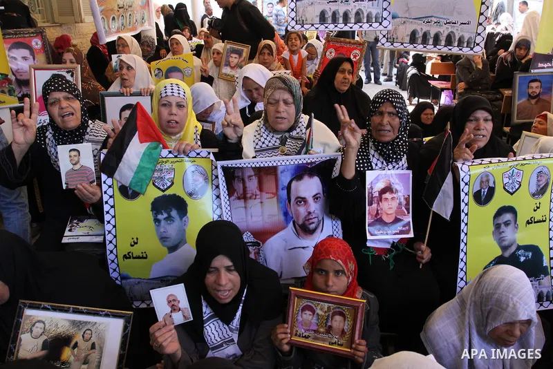 Palestinian women hold pictures of jailed relatives during a protest in Gaza city calling for their release from Israeli prisons at the headquarters of the International Red Cross in Gaza City May 9, 2011. Photo by Moham...