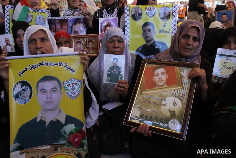 Palestinian women hold pictures of jailed relatives during a protest in Gaza city calling for their release from Israeli prisons at the headquarters of the International Red Cross in Gaza City May 9, 2011. Photo by Moham...