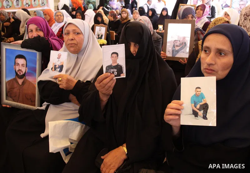 Palestinian women hold pictures of jailed relatives during a protest in Gaza city calling for their release from Israeli prisons at the headquarters of the International Red Cross in Gaza City May 9, 2011. Photo by Moham...