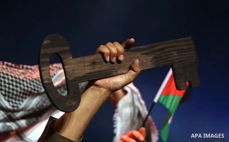 Palestinians hold flags and symbolic keys during a celebration in the West Bank city of Ramallah, Sunday, May 8, 2011 to commemorate the 63rd anniversary of Nakba, or catastrophe, the Arabic term used to describe the upr...