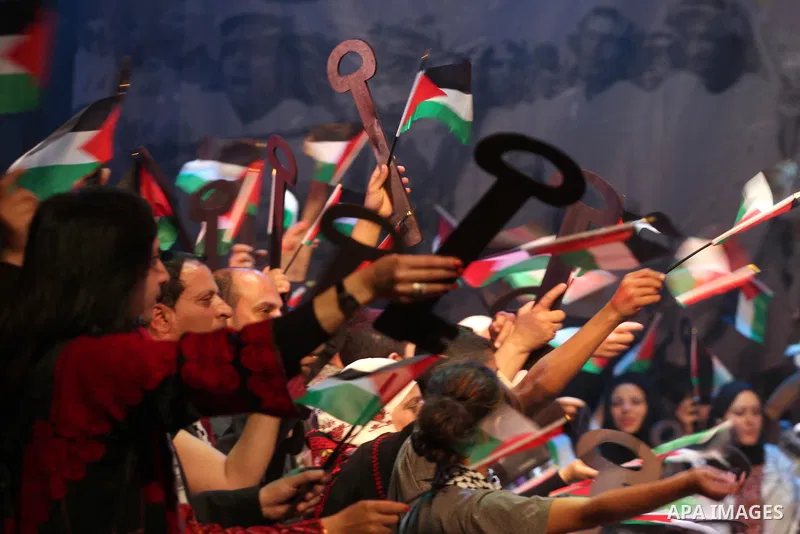 Palestinians hold flags and symbolic keys during a celebration in the West Bank city of Ramallah, Sunday, May 8, 2011 to commemorate the 63rd anniversary of Nakba, or catastrophe, the Arabic term used to describe the upr...