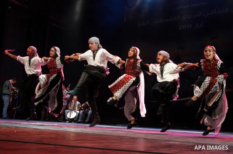 Palestinians, from Lebanon refugee camps, perform traditional dancing Dabka during a celebration at the Cultural Palace in the West Bank city of Ramallah on May 8,2011. Photo by Issam Rimawi