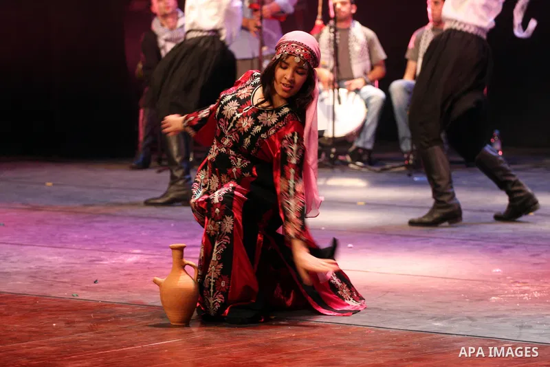 Palestinians, from Lebanon refugee camps, perform traditional dancing Dabka during a celebration at the Cultural Palace in the West Bank city of Ramallah on May 8,2011. Photo by Issam Rimawi