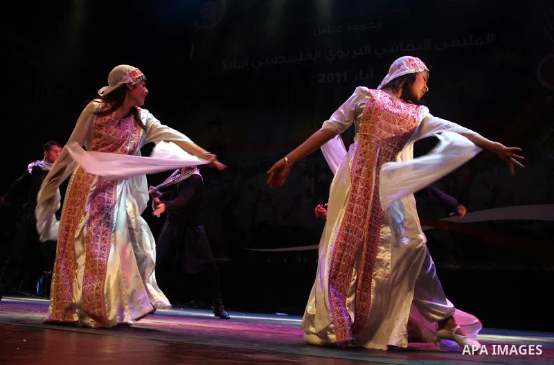 Palestinians, from Lebanon refugee camps, perform traditional dancing Dabka during a celebration at the Cultural Palace in the West Bank city of Ramallah on May 8,2011. Photo by Issam Rimawi