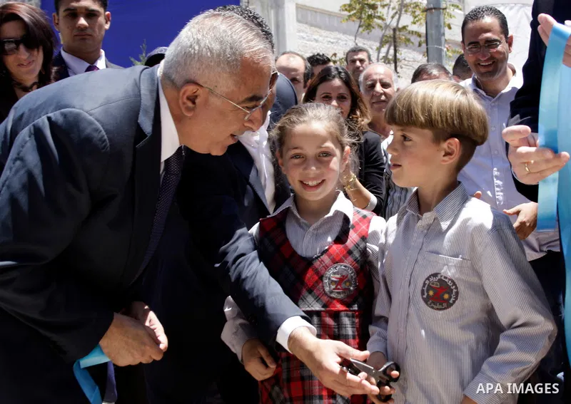 Palestinian Prime Minister, Salam Fayyad participates in a celebration to mark "Europe Day" in the West Bank city of Ramallah on May 9, 2011. France announced it would donate 10 million euros to the Palestinian Authority...