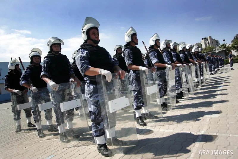 palestinian Hamas security forces march with their riot gear during a graduation ceremony at the Arafat police compound in Gaza City on May 10, 2011. Photo by Mohammed Othman