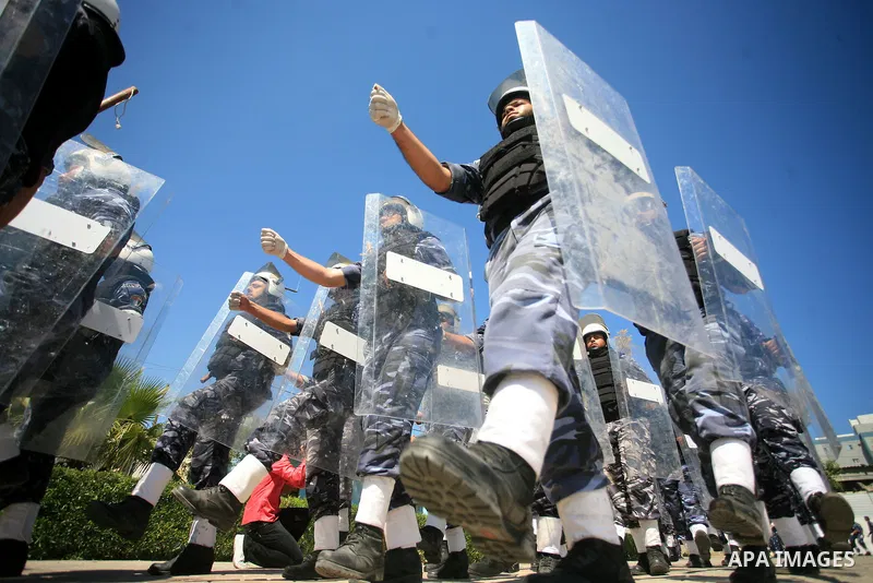 palestinian Hamas security forces march with their riot gear during a graduation ceremony at the Arafat police compound in Gaza City on May 10, 2011. Photo by Mohammed Othman