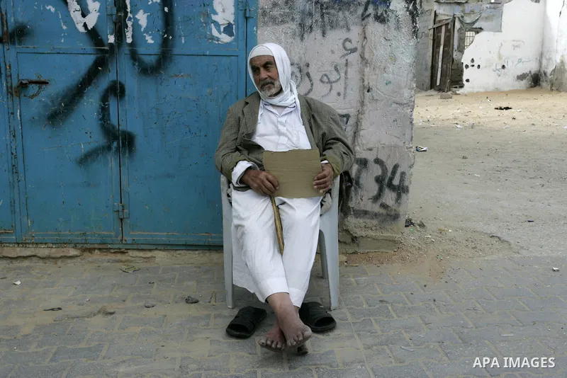 A Palestinian refugee sits in front his house in the Rafah refugee camp on May 10, 2011. Palestinians commemorate the 63rd anniversary of Nakba, or catastrophe, the Arabic term used to describe the uprooting of hundreds...