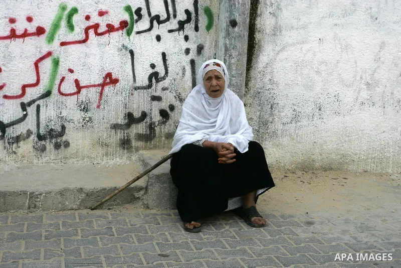 A Palestinian refugee sits in front his house in the Rafah refugee camp on May 10, 2011. Palestinians commemorate the 63rd anniversary of Nakba, or catastrophe, the Arabic term used to describe the uprooting of hundreds...