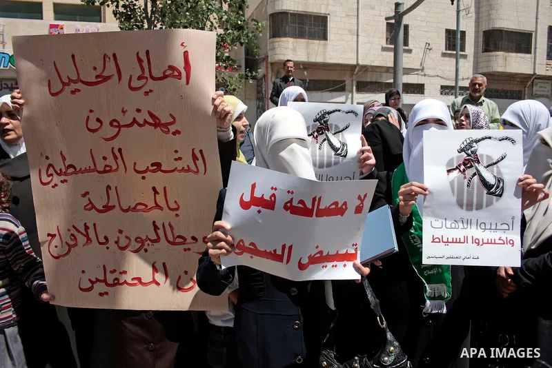 Palestinian women supporters of the Hamas Islamist movement take part in a rally calling for the release of Palestinians being held in West Bank and Gaza Strip jails in the West Bank city of Hebron on May 10, 2011. Photo...