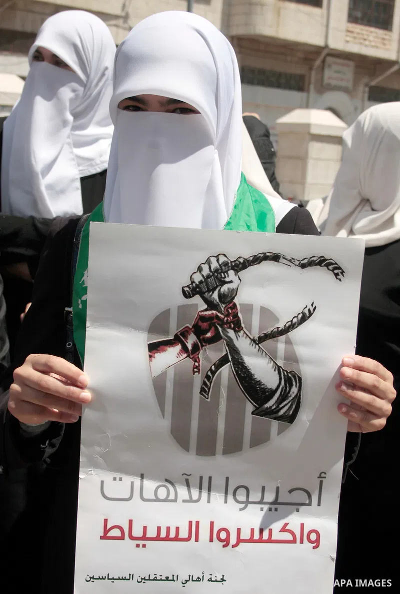 Palestinian women supporters of the Hamas Islamist movement take part in a rally calling for the release of Palestinians being held in West Bank and Gaza Strip jails in the West Bank city of Hebron on May 10, 2011. Photo...