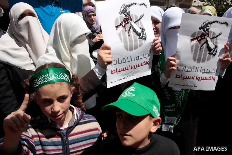 Palestinian women supporters of the Hamas Islamist movement take part in a rally calling for the release of Palestinians being held in West Bank and Gaza Strip jails in the West Bank city of Hebron on May 10, 2011. Photo...