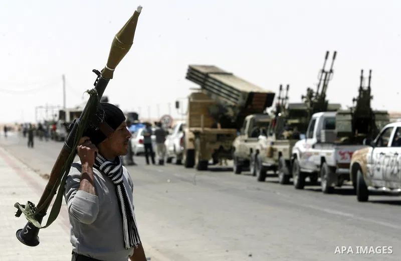 Libyan rebel fighters head towards the front line outside the Libyan eastern city Ajdabiya on May 10, 2011, where fighting between rebels and forces loyal to leader Moamer Kadhafi is ongoing. Photo by Wissam Nassar