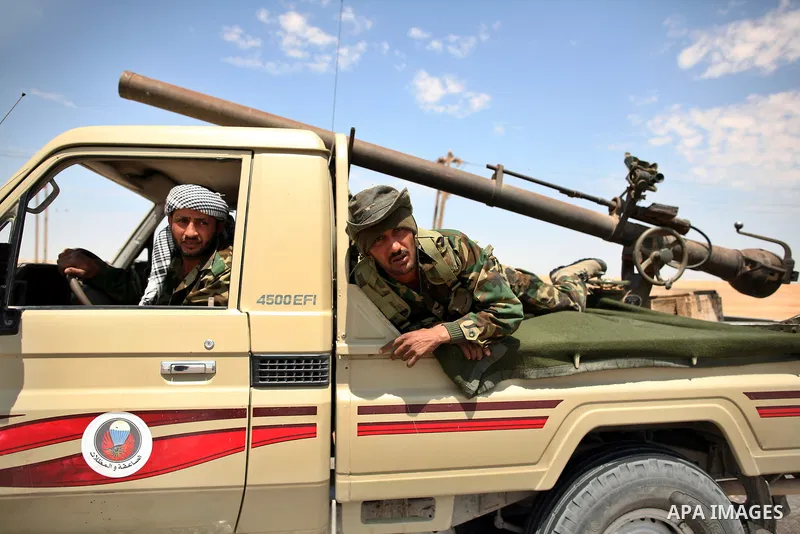 Libyan rebel fighters head towards the front line outside the Libyan eastern city Ajdabiya on May 10, 2011, where fighting between rebels and forces loyal to leader Moamer Kadhafi is ongoing. Photo by Wissam Nassar