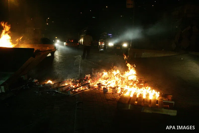 Palestinian youths prepare to hurl stones toward Israeli soldiers during clashes in the flashpoint east Jerusalem neighbourhood of Silwan on May 10, 2011. Photo by Mahfouz Abu Turk