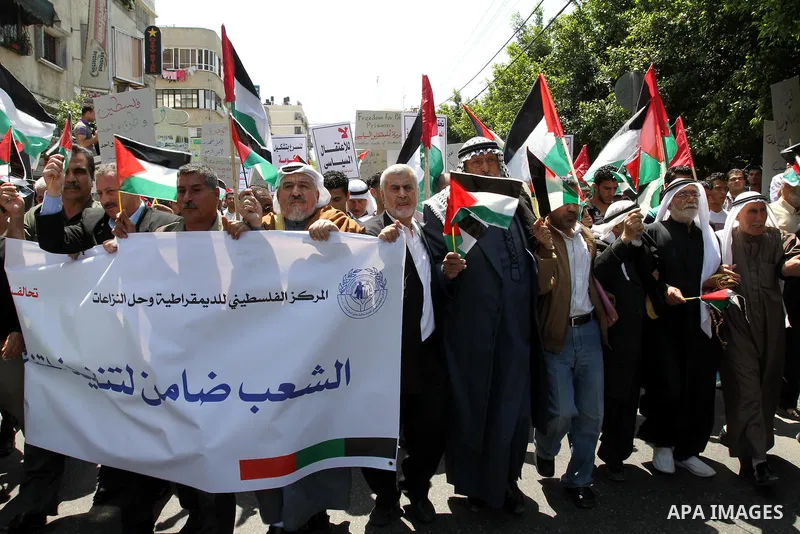 Palestinians hold their national flag and chant slogans during a rally in Gaza city on May 11,2011 calling Fatah and Hamas movements to unit and deal with reconciliation agreement. Photo by Mohammed Asad