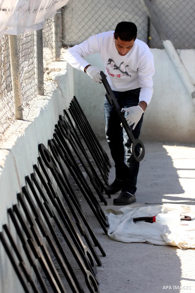 Palestinians paint slogans on keys symbolizing the homes people lost in 1948 when the Jewish state of Israel was created, on May 11, 201 in the West Bank Qalandia refugee camp near Jerusalem, during a preparation to mark...