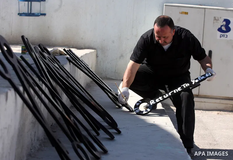 Palestinians paint slogans on keys symbolizing the homes people lost in 1948 when the Jewish state of Israel was created, on May 11, 201 in the West Bank Qalandia refugee camp near Jerusalem, during a preparation to mark...