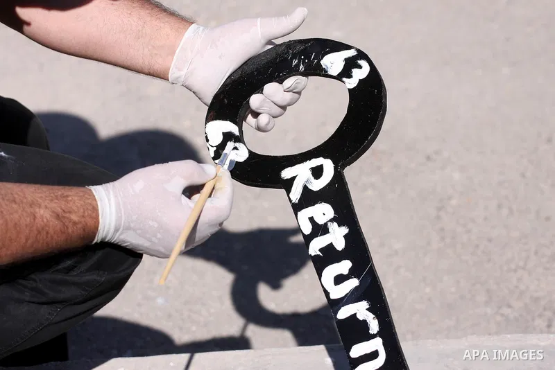 Palestinians paint slogans on keys symbolizing the homes people lost in 1948 when the Jewish state of Israel was created, on May 11, 201 in the West Bank Qalandia refugee camp near Jerusalem, during a preparation to mark...