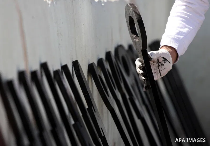 Palestinians paint slogans on keys symbolizing the homes people lost in 1948 when the Jewish state of Israel was created, on May 11, 201 in the West Bank Qalandia refugee camp near Jerusalem, during a preparation to mark...
