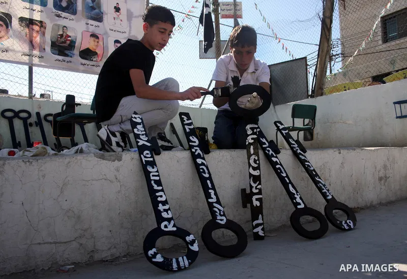 Palestinians paint slogans on keys symbolizing the homes people lost in 1948 when the Jewish state of Israel was created, on May 11, 201 in the West Bank Qalandia refugee camp near Jerusalem, during a preparation to mark...