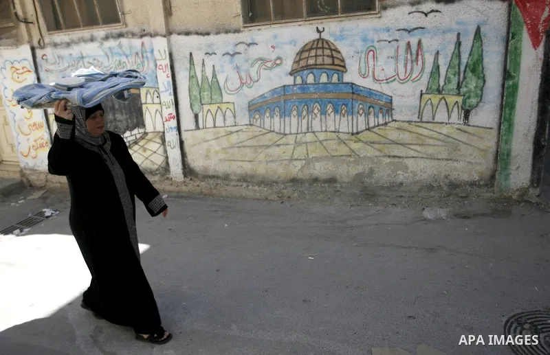 A Palestinian woman walks in a street in the West Bank Balata refugee camp, near Nablus on May 11, 2011, as Palestinians mark the 63rd anniversary of the "Nakba" (catastrophe). Nakba means "catastrophe" in reference to t...