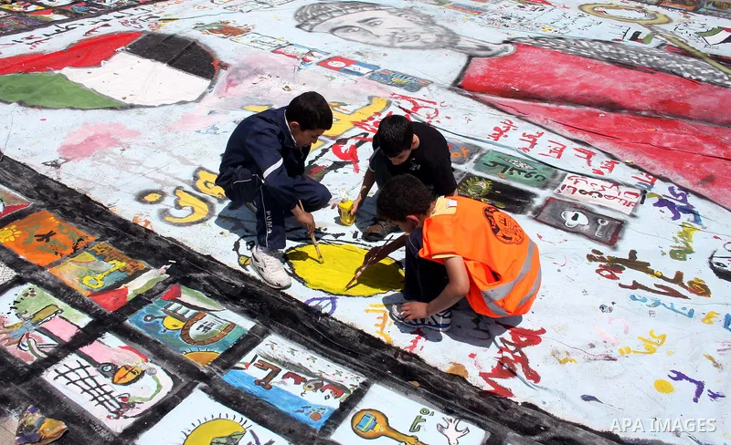 Palestinian students prepare a big mural to mark the 63th anniversary of "Nakba" (catastrophe), in the West Bank city of Ramallah, on May 12, 2011. Nakba means "catastrophe" in reference to the birth of the state of Isra...