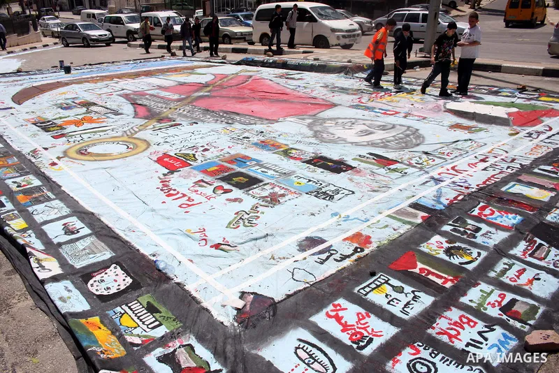 Palestinian students prepare a big mural to mark the 63th anniversary of "Nakba" (catastrophe), in the West Bank city of Ramallah, on May 12, 2011. Nakba means "catastrophe" in reference to the birth of the state of Isra...