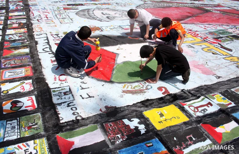 Palestinian students prepare a big mural to mark the 63th anniversary of "Nakba" (catastrophe), in the West Bank city of Ramallah, on May 12, 2011. Nakba means "catastrophe" in reference to the birth of the state of Isra...