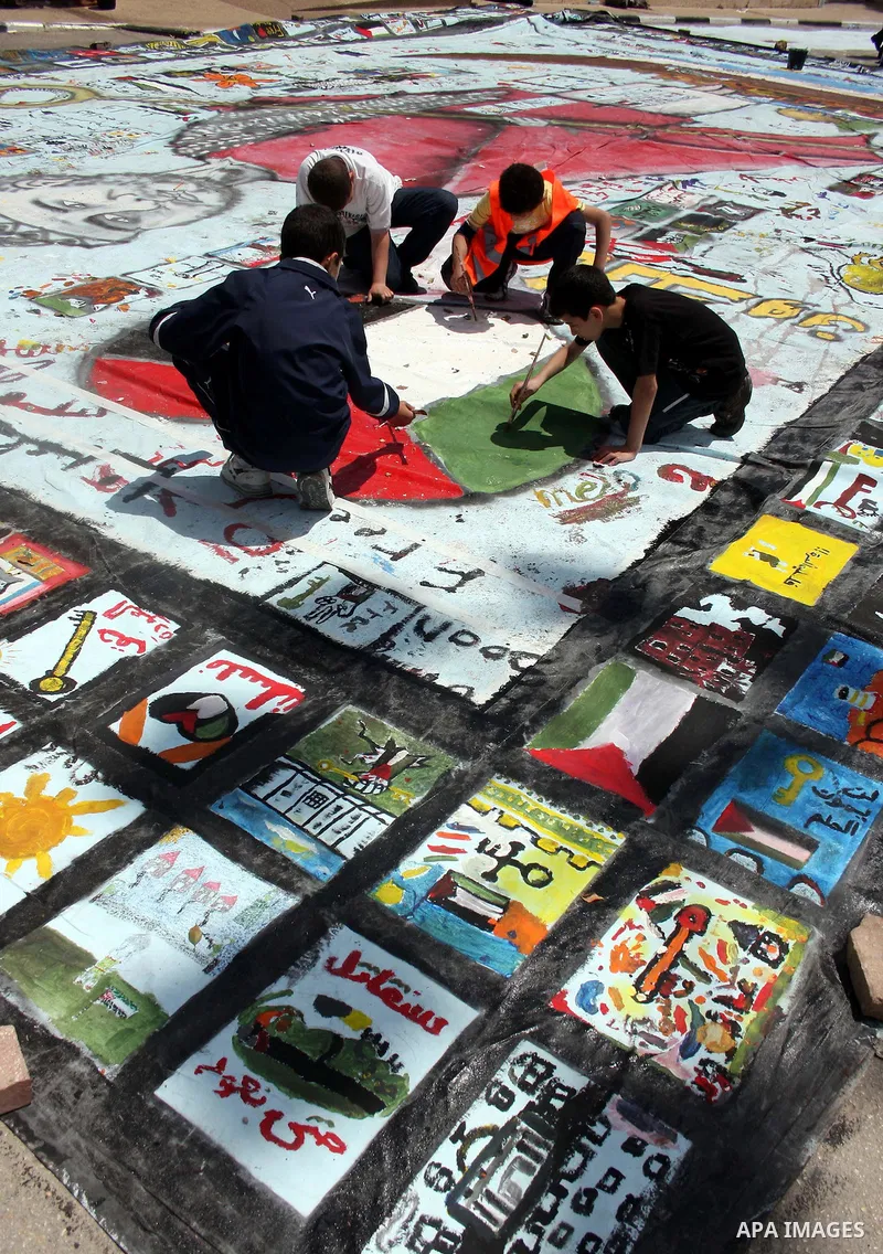 Palestinian students prepare a big mural to mark the 63th anniversary of "Nakba" (catastrophe), in the West Bank city of Ramallah, on May 12, 2011. Nakba means "catastrophe" in reference to the birth of the state of Isra...