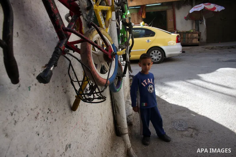Palestinian children walk at streets of the Amari refugee camp, near Ramallah in the West Bank 12 May 2011. Nakba means "catastrophe" in reference to the birth of the state of Israel 63 years ago in British-mandate Pales...