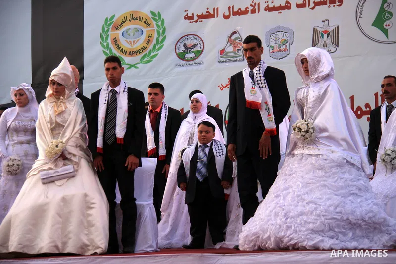 Palestinian brides and grooms take part in a mass wedding ceremony for disabled couples in the West Bank city of Nablus, Thursday, May 12, 2011. The wedding was sponsored by the United Arab Emirates and the Fatah movemen...