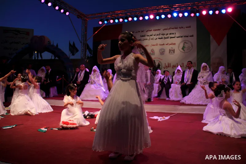 Palestinian brides and grooms take part in a mass wedding ceremony for disabled couples in the West Bank city of Nablus, Thursday, May 12, 2011. The wedding was sponsored by the United Arab Emirates and the Fatah movemen...