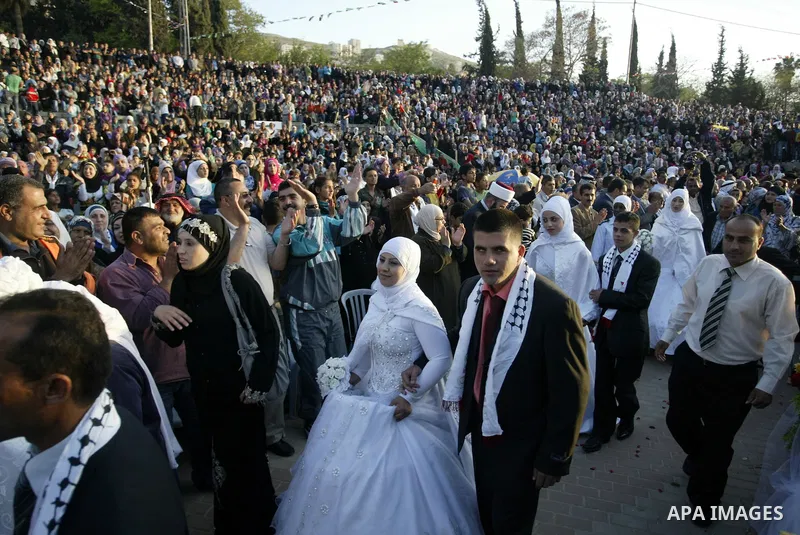 Palestinian brides and grooms take part in a mass wedding ceremony for disabled couples in the West Bank city of Nablus, Thursday, May 12, 2011. The wedding was sponsored by the United Arab Emirates and the Fatah movemen...