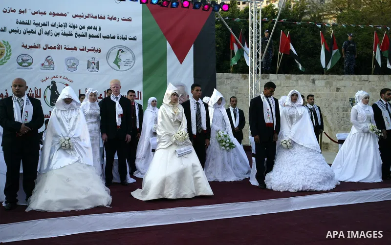 Palestinian brides and grooms take part in a mass wedding ceremony for disabled couples in the West Bank city of Nablus, Thursday, May 12, 2011. The wedding was sponsored by the United Arab Emirates and the Fatah movemen...