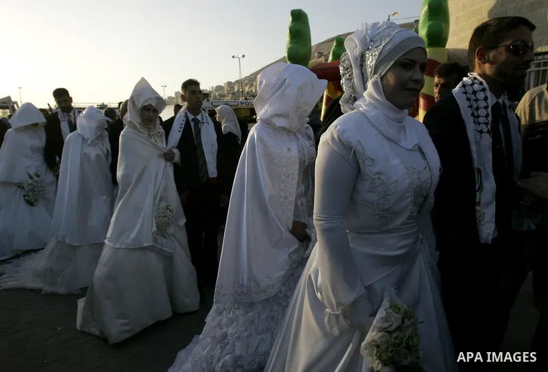Palestinian brides and grooms take part in a mass wedding ceremony for disabled couples in the West Bank city of Nablus, Thursday, May 12, 2011. The wedding was sponsored by the United Arab Emirates and the Fatah movemen...