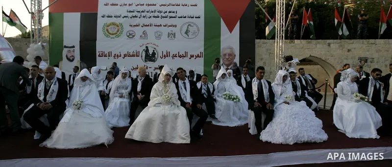 Palestinian brides and grooms take part in a mass wedding ceremony for disabled couples in the West Bank city of Nablus, Thursday, May 12, 2011. The wedding was sponsored by the United Arab Emirates and the Fatah movemen...
